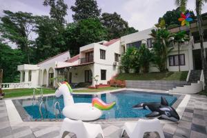 a pool in front of a house with a pool noodleitatingitatingitating shark at 40P, Bangsar Villa with Pool/Karaoke/Gathering/BBQ in Kuala Lumpur