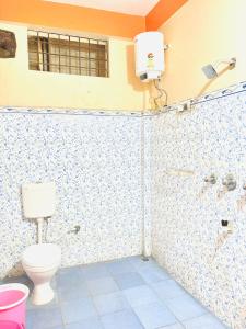 a bathroom with a toilet and a shower at Serene Homestay in Sibsāgar