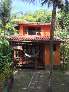 a house with a hammock in front of it at Vila Sofia chalès in Morro de São Paulo
