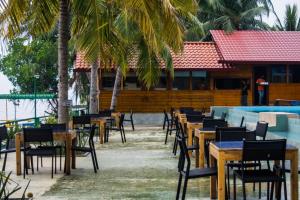 a row of tables and chairs next to a swimming pool at New saniro Lagoon Deck in Katunayake