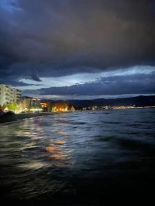 a view of a body of water at night at Pogradec Sunilio Apartment in Pogradec