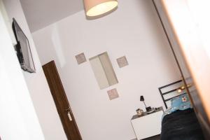 a bedroom with a bed and a tv and a door at Studio Sonia - Tordosan Central - #5 in Sibiu