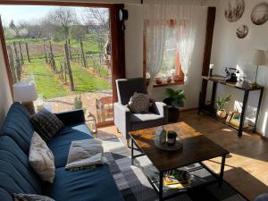 a living room with a blue couch and a table at Szofi Porta in Marcali