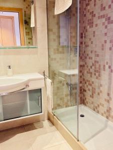 a bathroom with a glass shower and a sink at Apartamento con vistas Peralada in Peralada +14 photos
