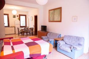 a bedroom with a bed and chairs and a table at Peaceful Portello home in Padova