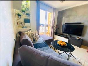 een woonkamer met een bank en een tafel bij Islan bay apartment in Agadir