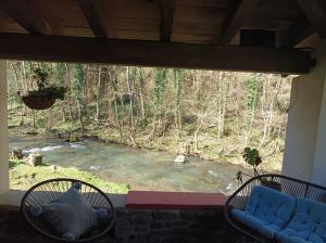 a view of a river from the porch of a house at Haraneko Errota Burdindegi in El Cerco