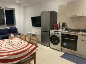 a kitchen with a table and a kitchen with a washing machine at Islan bay apartment in Agadir