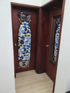 two surfboards hanging on a wall in a room at Decent and cosy one bed flat - Bella Vista in Entebbe