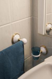 a bathroom with a blue towel next to a sink at Estrela de mar in O Grove +11 photos
