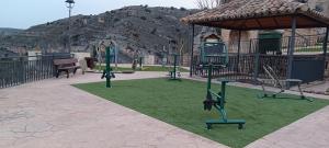 a park with a playground with a swing set at Casa Rural Reyes in Nuévalos