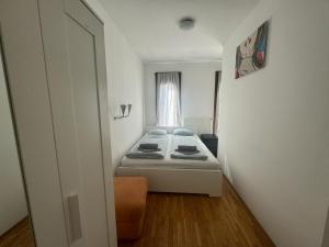 a small bedroom with a bed and a window at K3 in Budapest