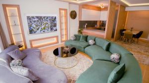 a living room with two couches and a table at Green Ilidza Apartment in Sarajevo