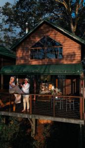 two people standing on the porch of a house at The Polish Place in Mount Tamborine