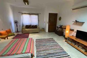 a large living room with a bed and a couch at Lighthouse studio in Dahab