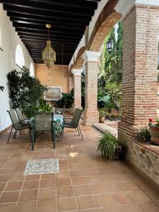 an outdoor patio with chairs and a table at Garden Suites Xativa in Xàtiva