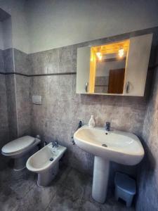 uma casa de banho com um lavatório e um WC em Casa Carmine - Casa Vacanza em Colleberardi