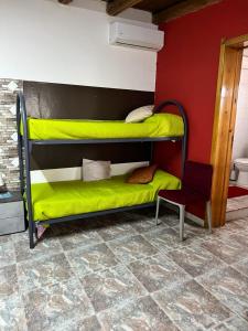 a room with two bunk beds and a chair at Marzamemi Da Giusy in Pachino