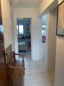a hallway with a room with a bed and a chair at Appartement calme et ensoleillé in Hérouville-Saint-Clair