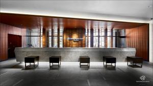 a lobby with tables and chairs in a building at Daiwa Roynet Hotel Nishi-Shinjuku PREMIER in Tokyo