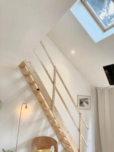 a staircase in a house with a skylight at Cocon Maritime 1 chambre & 1 Mezzanine in Ouistreham