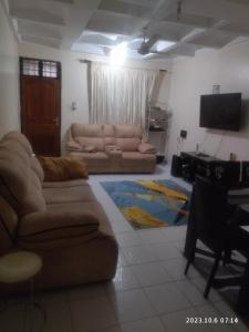 a living room with a couch and a television at Sp Accommodations in Mombasa