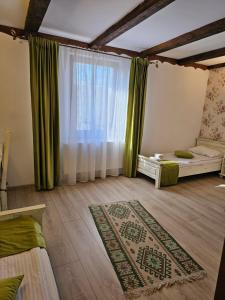 a room with two beds and a window at Hanul Vestem in Sibiu