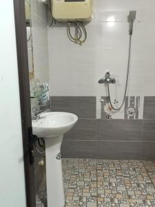 een badkamer met een wastafel en een douche bij Nhà nghỉ bình dân Huy Nhung in Ha Giang