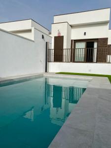 a house with a swimming pool in front of it at Casa de Goya in Argés
