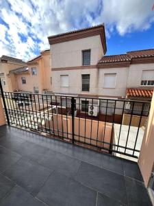 a balcony with a fence in front of a building at Casa para grupos en Granada in Granada