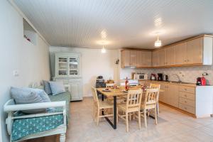 a kitchen and dining room with a table and chairs at Dellaporta's Cottage in Makriótika