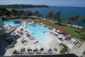 an aerial view of a resort with a swimming pool at Hotel Parentium Plava Laguna in Poreč