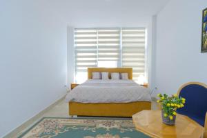 a bedroom with a bed and a window at Primus Apartments in Visoko