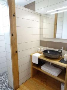 a bathroom with a sink and a mirror at Terre et Eau chambres d'hotes B&B La Flocellière in La Flocellière