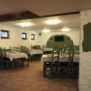 a dining room with tables and chairs and a tv at Hanul Vestem in Sibiu