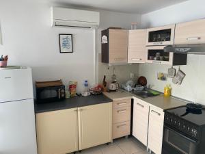 a kitchen with a white refrigerator and a microwave at Sea house in Bibinje