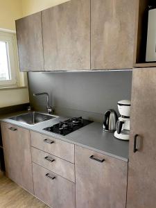 a kitchen with a sink and a stove at Residence Alesi in Malcesine