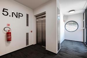 an office hallway with a fire extinguisher on the wall at Ski&Bike apartmán INFFINITY in Janske Lazne