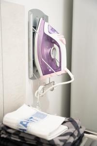 a hair dryer is hanging on a wall at Le Noyer - moderne - spacieux - parking in Montaigu-Vendée +14 photos