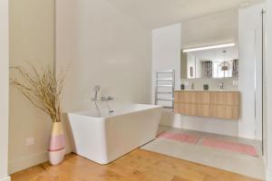 a white bathroom with a sink and a mirror at Coeur de Presqu’île Hotel Dieu in Lyon