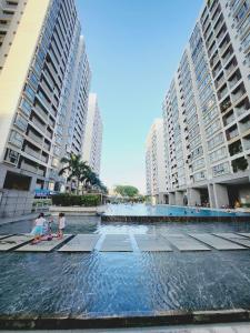 two children playing in a pool in a city with tall buildings at Scenic Valley 2 in Ho Chi Minh City