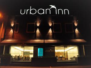 a sign on the front of a restaurant at night at Urban Inn Kulim in Kulim