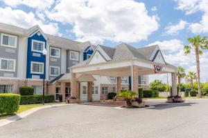 a large building with a driveway in front of it at Microtel Inn & Suites by Wyndham Kingsland Naval Base I-95 in Kingsland