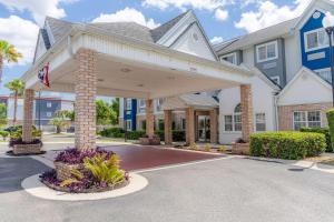 a home with a covered driveway in front of it at Microtel Inn & Suites by Wyndham Kingsland Naval Base I-95 in Kingsland