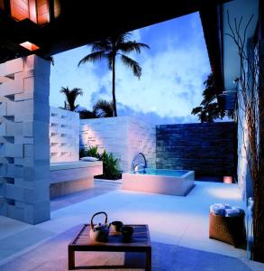 a patio with a bath tub and a table at Grand Hyatt Bali in Nusa Dua