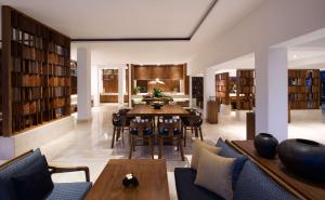 a dining room with a table and chairs in a library at Grand Hyatt Bali in Nusa Dua