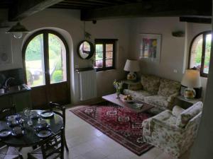 a living room with a couch and a table at Private Villa Dolce Vita in Lucignano