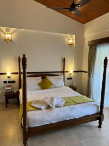 a bedroom with a large bed with towels on it at Mastiff Grand La Villae in Lonavala