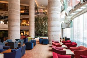 a lobby with columns and colorful chairs in a building at Grand Hyatt Fukuoka in Fukuoka