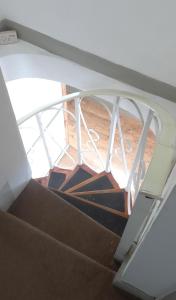 an overhead view of a spiral staircase with a stair case at Homestay CR7 in Thornton Heath